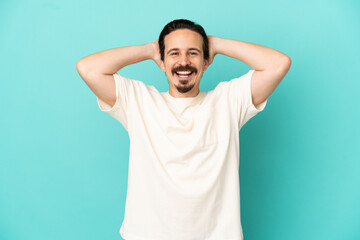 Fototapeta na wymiar Young caucasian man isolated on blue background laughing