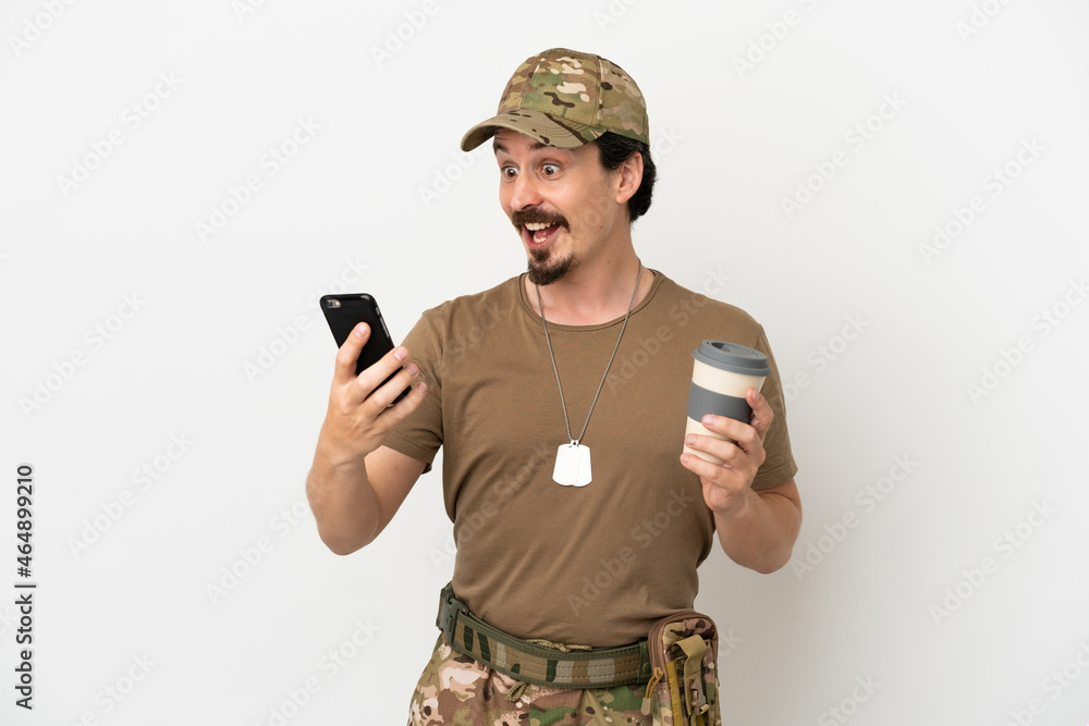 Wall mural Soldier man isolated on white background holding coffee to take away and a mobile