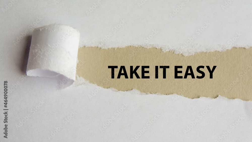 Aufkleber take it easy. words. text on gray paper on torn paper background