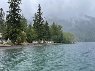 Crescent lodges and spruces on a lakeside in Olympic National park, Washington on a foggy day