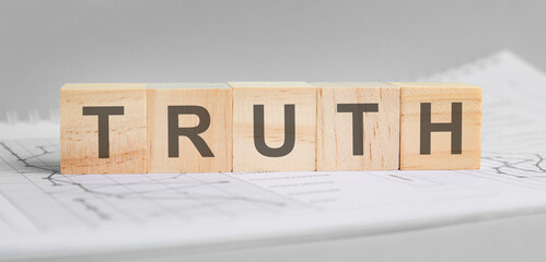 truth word on wood cube blocks on gray background.