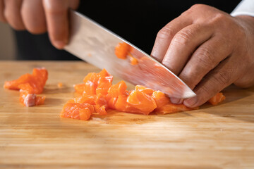 Close up to Slicing Cube Salmon by motion movement Knife by Prefessional Chef.