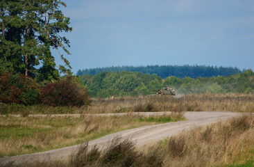 Obraz premium British army FV107 Scimitar CVRT armoured tracked military reconnaissance vehicle in action on a military exercise Wiltshire UK