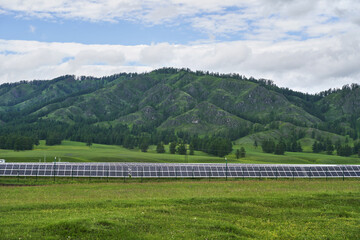 Vacation landscape. Russian Altai mountains. Staycation concept. Reduce carbon footprint. Sustainable lifestyle. Holiday trail. Local travel. Sun energy panels. Electricity generator. Hill background