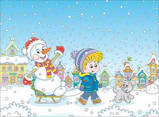 Happy little boy walking with his merry pup and sledding a funny snowman down a snow-covered street of a pretty small town on a beautiful snowy winter day, vector cartoon illustration