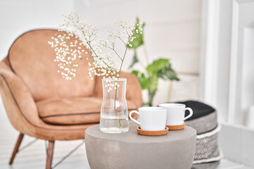White cups on a concrete table. two cups of hot coffee. Concept of renting an apartment or bed and Breakfast