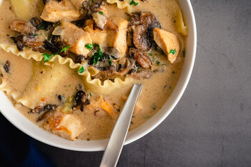 Roasted Garlic White Chicken Lasagna Soup: Bowl of soup made with lasagne noodles, alfredo sauce, and mushrooms