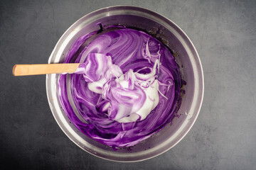 Mixing Meringue into Ube Cake Batter: Using a spatula to mix up cake batter made with purple sweet...