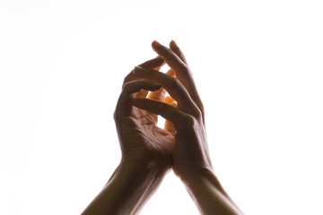 Hands make magic, or pray that the light falls from above on hand. Radiance between the palms.