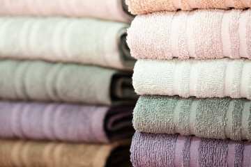 Colorful folded towels stack closeup picture.