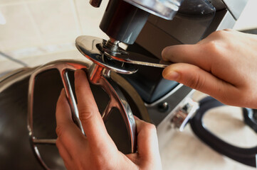 The  hands changes the tool to the food processor. Change of a nozzle of the Kitchen Machine....