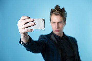 Brag about your success on social networks. A young man has received an achievement and takes a selfie.