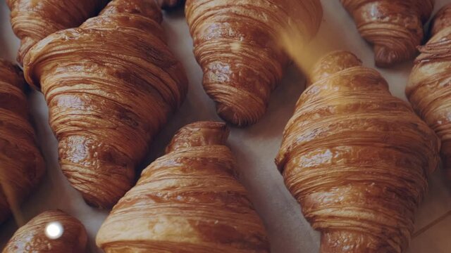 French croissants. Showcase with fresh golden classic croissants top view. High quality 4k footage