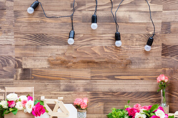 Obraz premium Wooden background with light bulbs. Copyspace. FLAT LAY