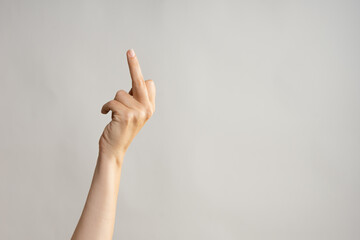 Hand gestures. Middle finger, aggressive gesture. Women's hand