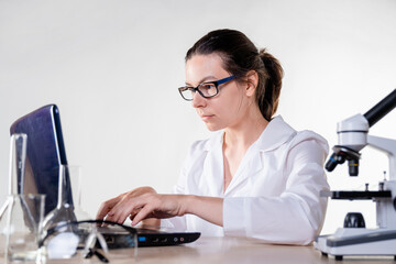 Big data in medicine and pharmacology, concept. A young woman, a laboratory assistant or a...