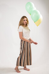 Sad girl with colored balls on a white background. (isolated on white)