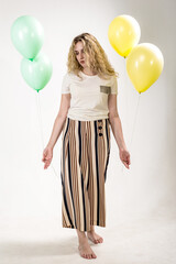 Sad girl with colored balls on a white background. (isolated on white)