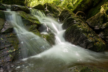 Long exposure of a waterfall on the Hoar Oak Water river at Watersmeet in Exmoor National Park