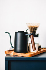 Fresh brewed coffee in a cup using Alternative method, with pour over dripper and paper filter.