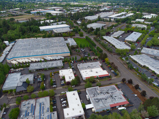 Small town. Many greens. Roofs of houses. Asphalt road roads and pedestrian walkways. View from above. Shooting from drone. Beauty of nature. Housing.