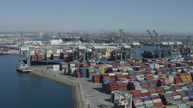 Aerial, sweeping footage of thousands commercial containers ready to be shipped in Long Beach port in California