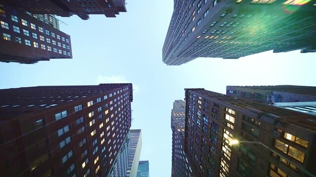 Looking up dolly shot of business skyscraper buildings in NYC. New York City is financial, economic and business center of America.