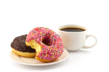 Still life with bitten colorful donut on plate and cup of black coffee isolated on a white...