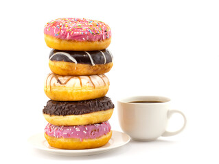 Big stack of assorted colorful donuts with various decoration and small cup of black coffee isolated on a white background. Concept background of world problem of obesity and unhealthy nutrition