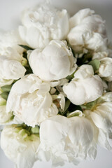 Naklejka na ściany i meble White peonies in a glass vase. Beautiful peony flower for catalog or online store. Floral shop concept . Beautiful fresh cut bouquet. Flowers delivery