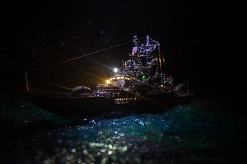 Silhouettes of a crowd standing at blurred military war ship on foggy background. Selective focus.