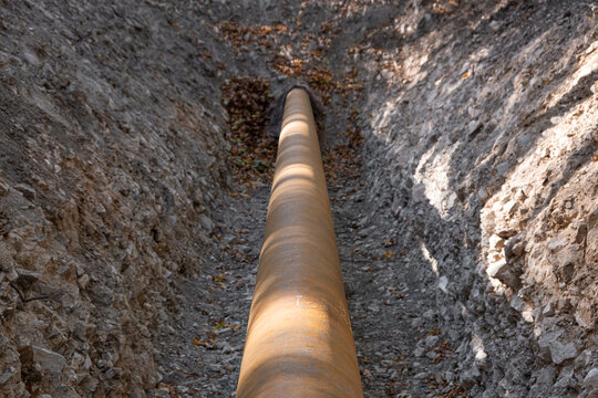 Propane gas communications infrastructure is buried underground. Gas or water supply Construction site with A iron steel rusty pipe corrosive