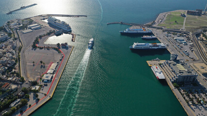 Fototapeta premium Aerial drone photo of famous and busy port of Piraeus where passenger ferries travel to Aegean destination islands as seen from high altitude , Attica, Greece