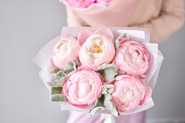 Two bouquet of Pink peonies in a women hand. Beautiful peony flower for catalog or online store. Floral shop concept . Beautiful fresh cut bouquet. Flowers delivery