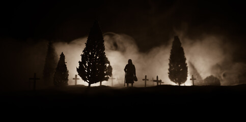 Diffuse entities walking on a street from an old European cemetery in moonlit night