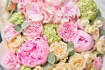 closeup Pink peonies and hydrangea. Beautiful bouquet of mixed flowers in woman hand. Floral shop concept . Handsome fresh bouquet. Flowers delivery.