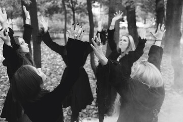 Coven of witches, a group of friends as witches on Halloween perform a ritual, lead a round dance and recite spells.