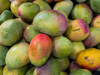 Fruits and vegetables background.  Healthy Living: Elevate Your Well-being with Nutritious Habits!  Close-up of mangos in a supermarket.