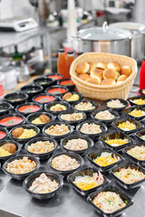 Food delivery. Different in plastic disposable lunch box with healthy natural food. Chicken broth, mashed soup, mashed potatoes with cutlet, seafood pasta, salads, pilaf with a fresh bun.