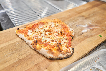 Pizza Margarita Heart-shaped for Valentine's day.. Baked tasty margherita pizza in Traditional wood oven in Neapolitan restaurant, Italy.
