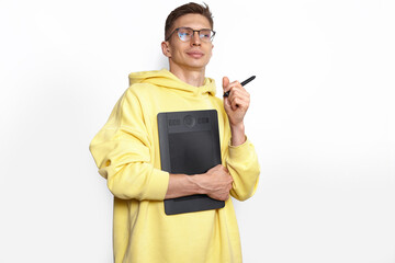 A male designer in yellow hoody holding graphic tablet