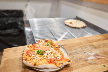 Pizza Margarita Heart-shaped for Valentine's day.. Baked tasty margherita pizza in Traditional wood oven in Neapolitan restaurant, Italy.