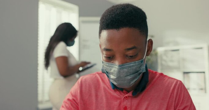 A busy woman stands at the blackboard holding a tablet, searches for the right graphic, prepares a diagram, a man sits at desk entering the data into the system needed to create the diagram