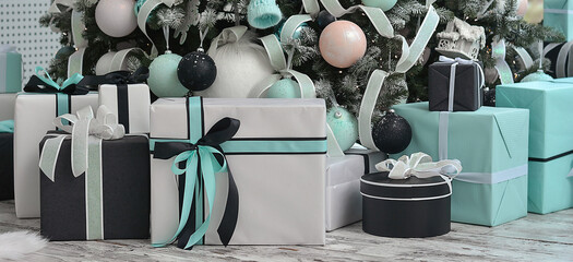 Many boxes with gifts near the Christmas tree.Christmas toys, decorations, gift boxes are decorated in white, blue and black colors