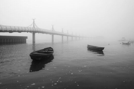 black and white photo of the boat and pier on the Vistula river in Plock during the fog 