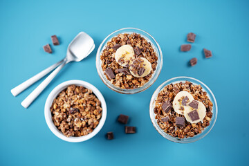 Chocolate and banana Greek yogurt granola parfait in a glass