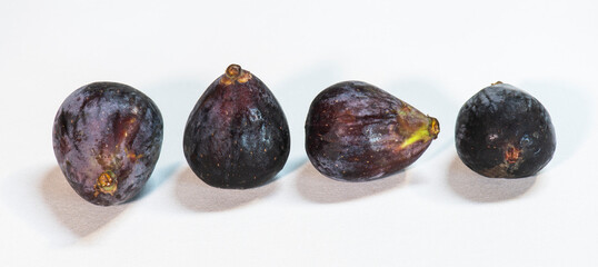 a row of four figs on a white background