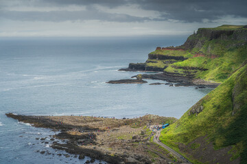 Fototapeta na wymiar Crowds of tourists visiting Giants Causeway, seen from top of the cliff, Wild Atlantic Way and UNESCO world heritage, located in Northern Ireland