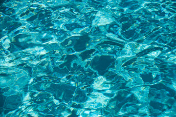 Abstract ripple wave and clear turquoise water surface in swimming pool, blue water wave for background and abstract design.