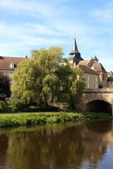 Fototapeta na wymiar La Celle Dunoise in France, bridge, church and buildings